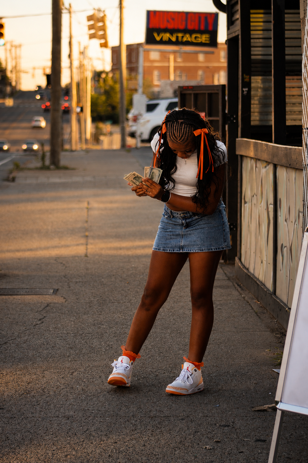 Harmoni counting money at sunset